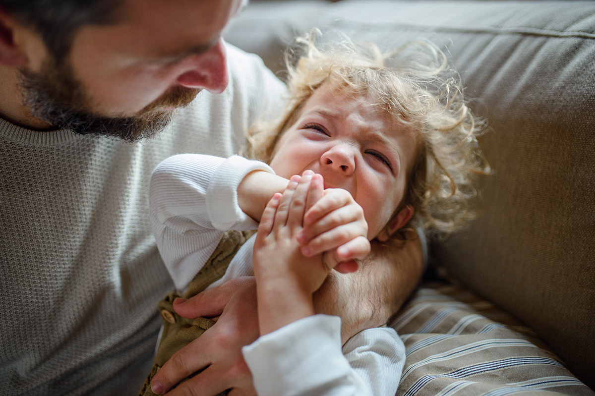 father-with-small-sick-crying-toddler-daughter-ind-2023-11-27-05-23-12-utc