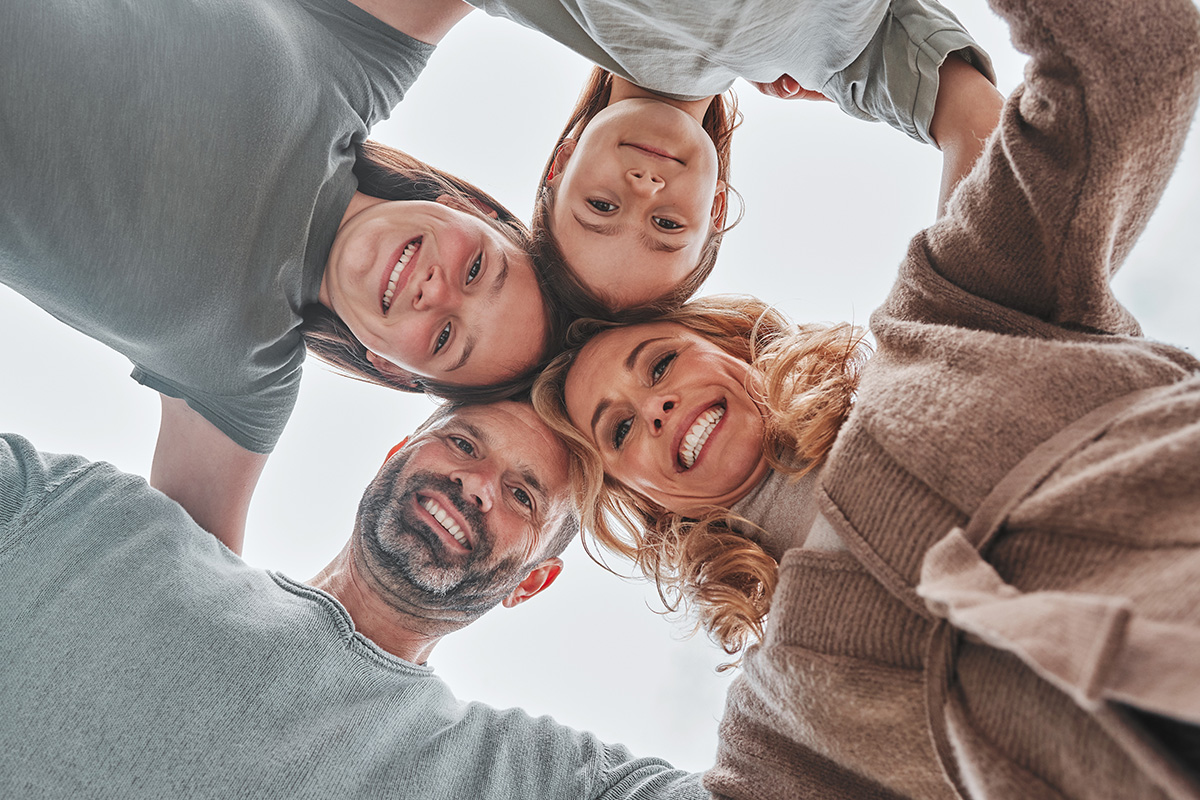 shot-of-a-family-of-four-standing-together-in-a-hu-2023-11-27-05-30-19-utc